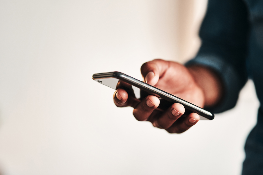Man holding phone in right hand
